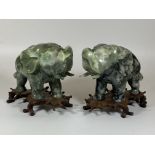 A PAIR OF CHINESE JADEITE / JADE HARDSTONE ELEPHANT MODELS ON CARVED WOODEN STANDS, HEIGHT 16CM,