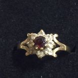 A 9CT GOLD RING WITH A RED GARNET AND CZ STONES, WEIGHT 1.7G, SIZE L