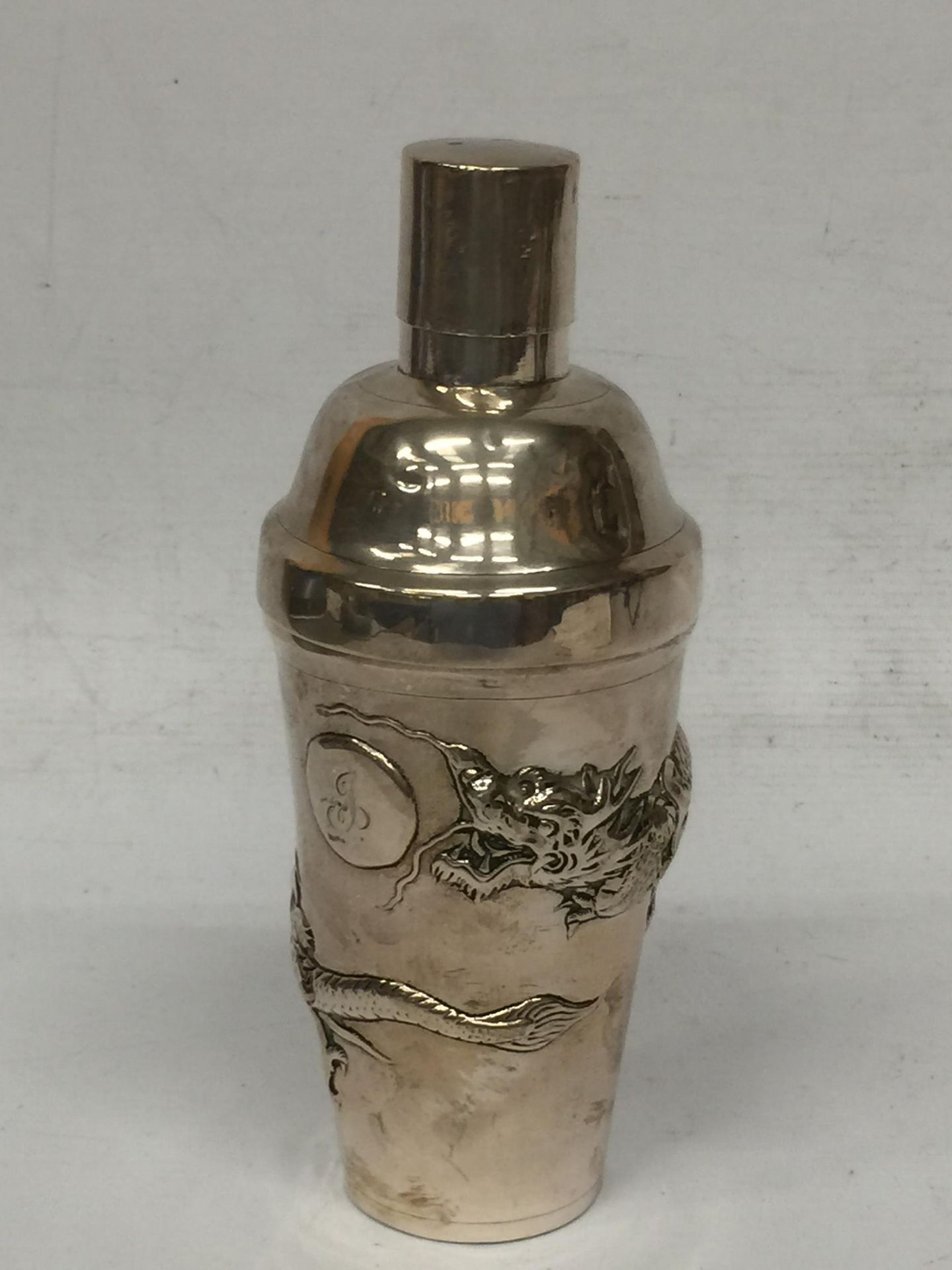 A BELIEVED SILVER CHINESE NANKING COCKTAIL SHAKER WITH DRAGON APPLIED DESIGN