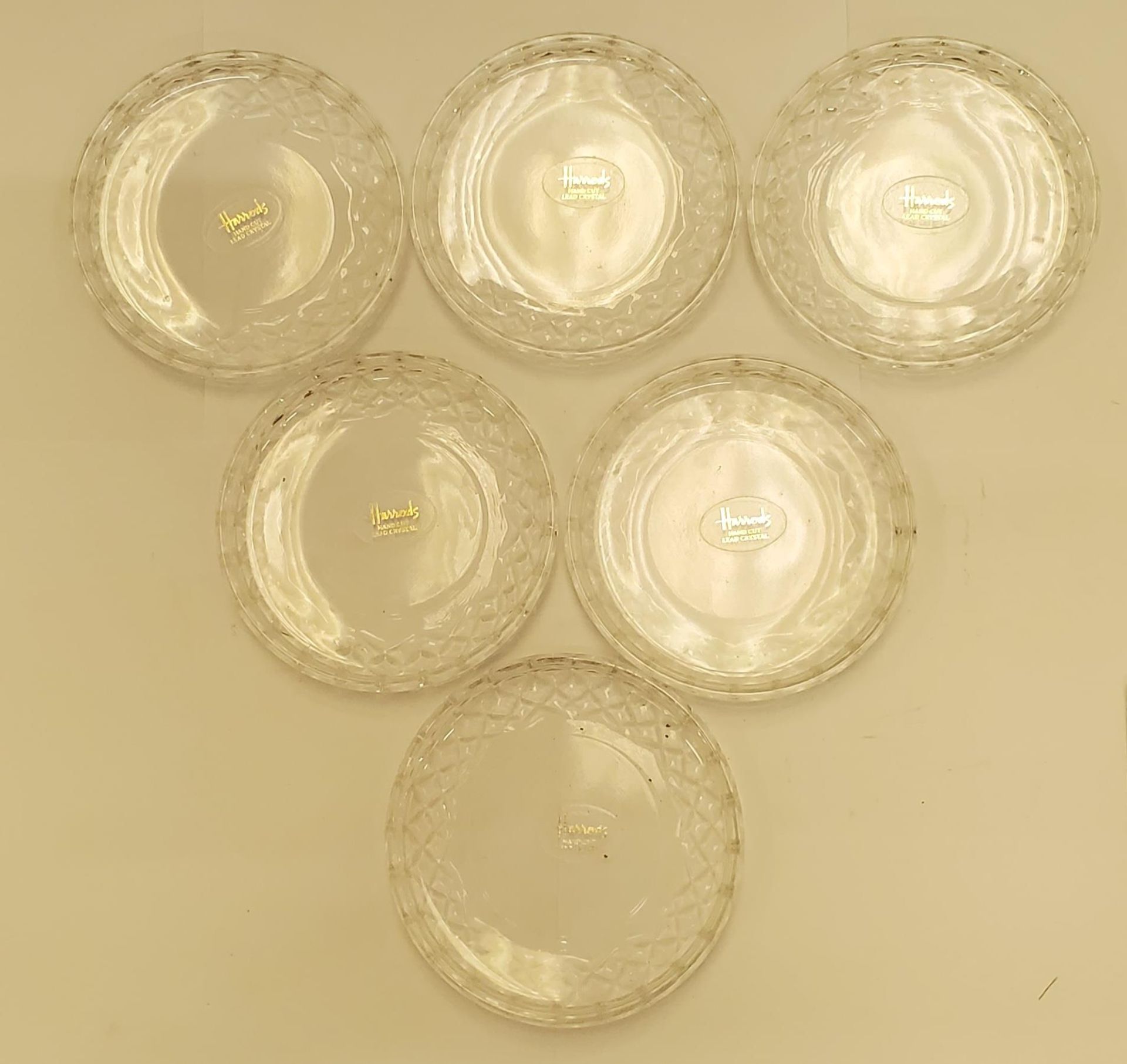 A SET OF SIX GLASS HARRODS, HAND CUT, LEAD CRYSTAL COASTERS