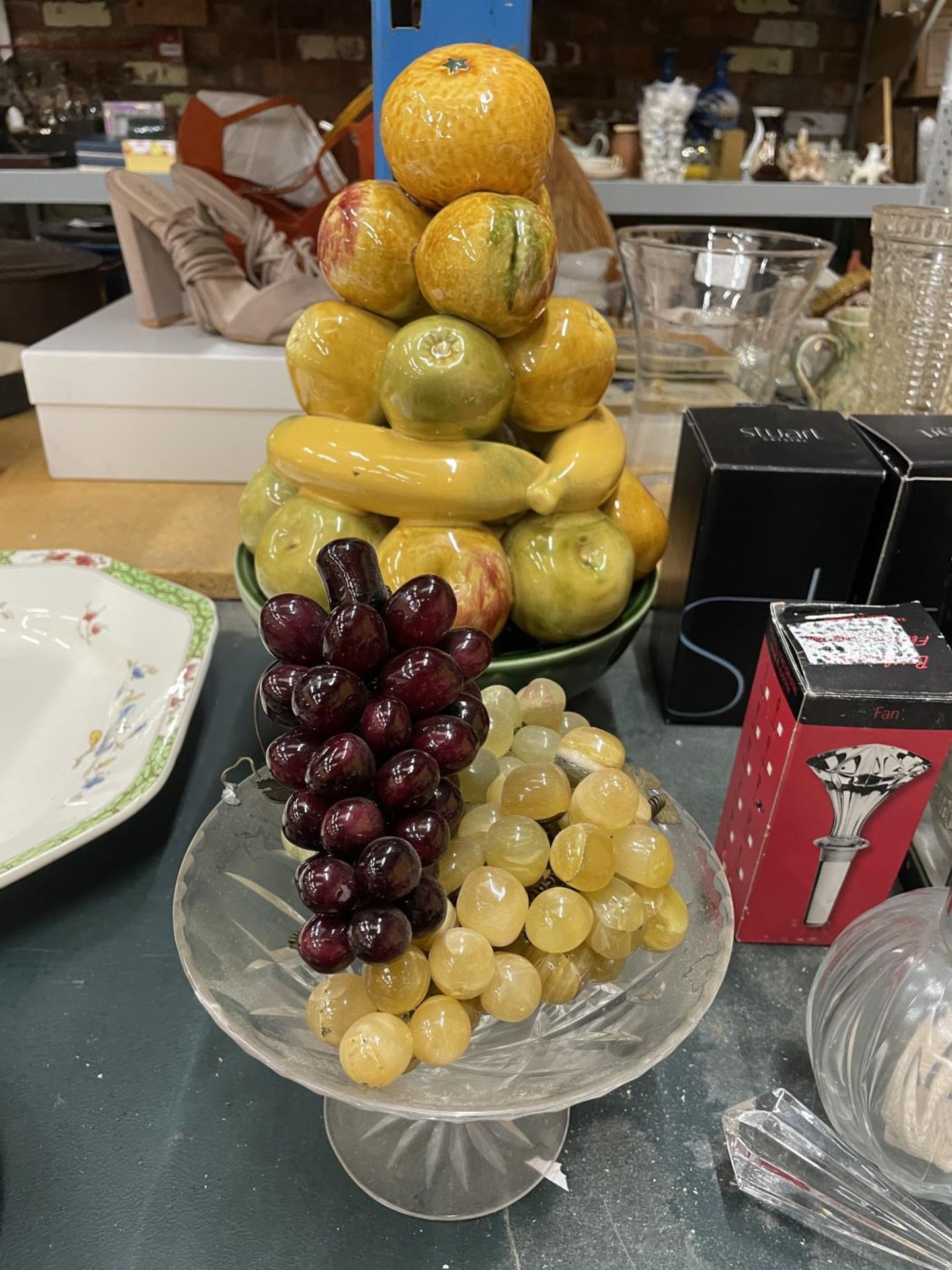 A VINTAGE BOWL OF CERAMIC FRUIT, A GLASS FOOTED BOWL AND THREE BUNCHES OF GLASS GRAPES