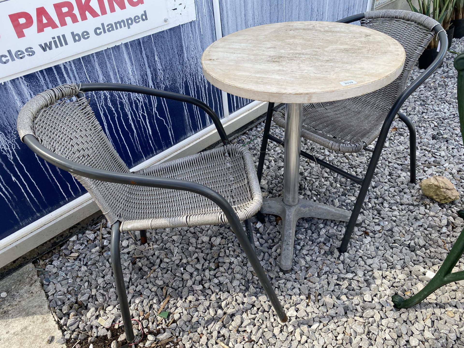 A BISTRO TABLE AND TWO CHAIRS