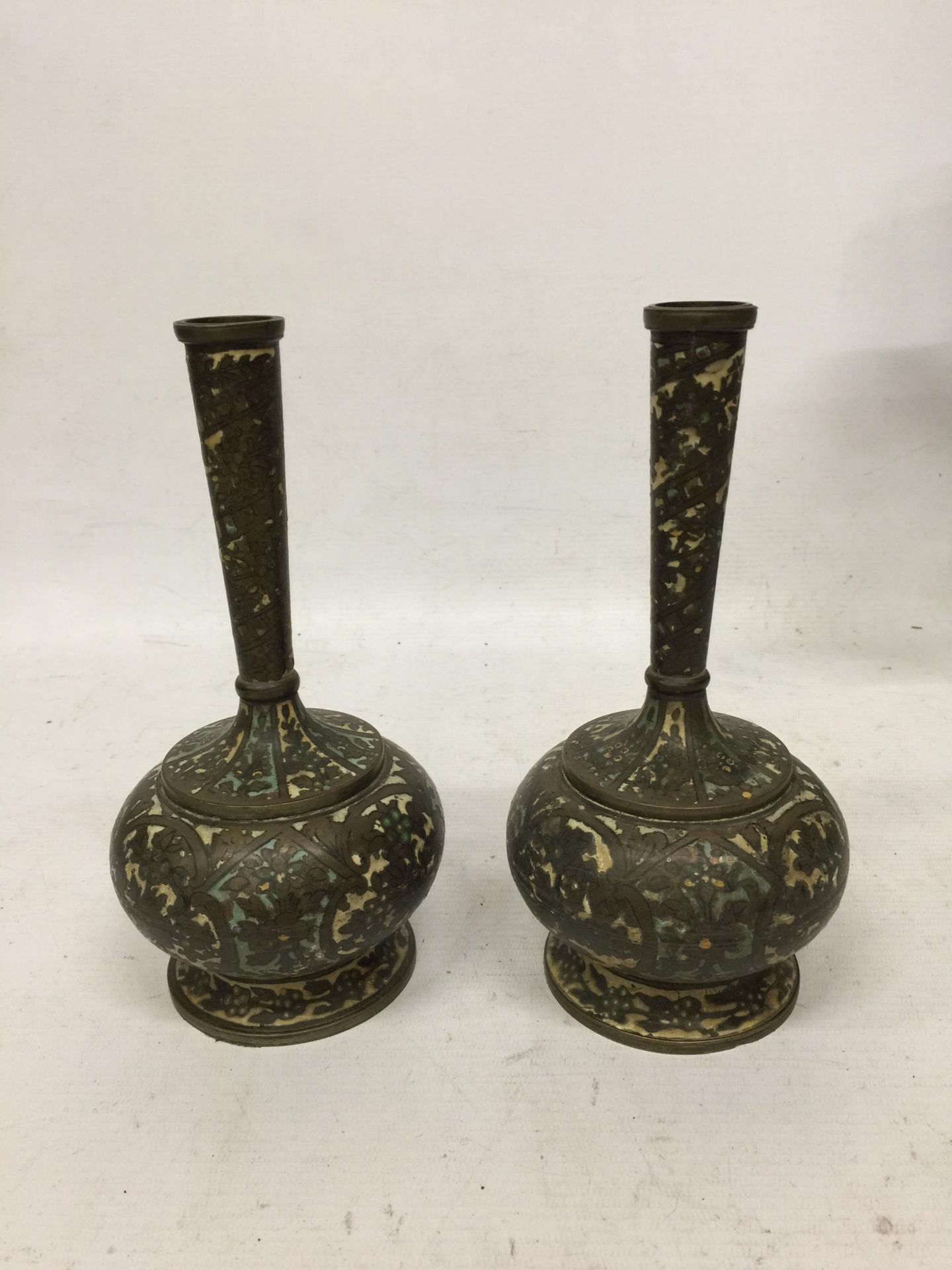 A PAIR OF VINTAGE MIDDLE EASTERN METALWARE CLOISONNE TYPE BOTTLE VASES