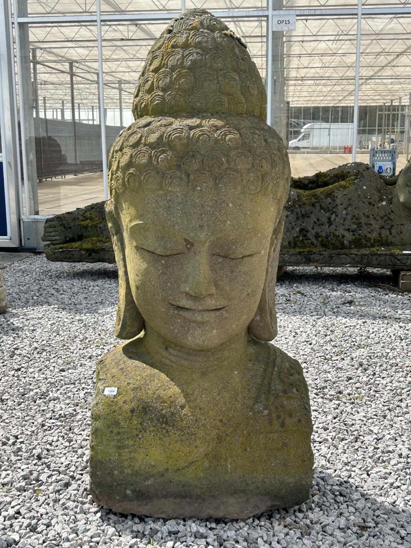 A LARGE RECONSTITUTED STONE BUDDHIST DIETY FIGURE - HEIGHT 150 CM, DEPTH 50 CM