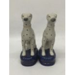 A PAIR OF STAFFORDSHIRE DALMATION ANIMAL FIGURES