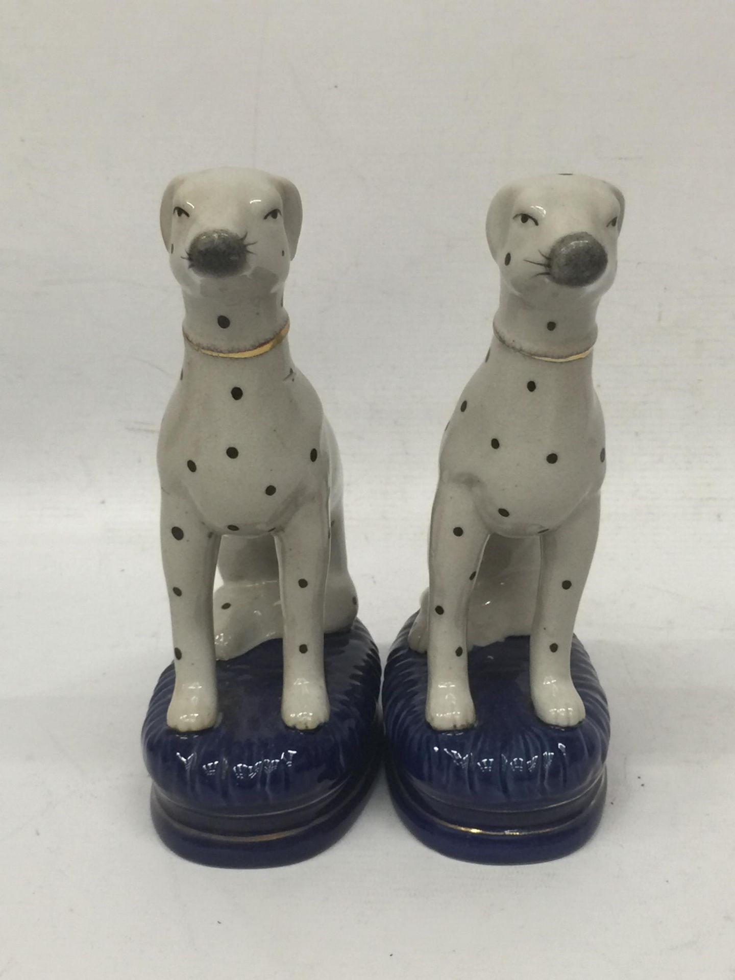 A PAIR OF STAFFORDSHIRE DALMATION ANIMAL FIGURES