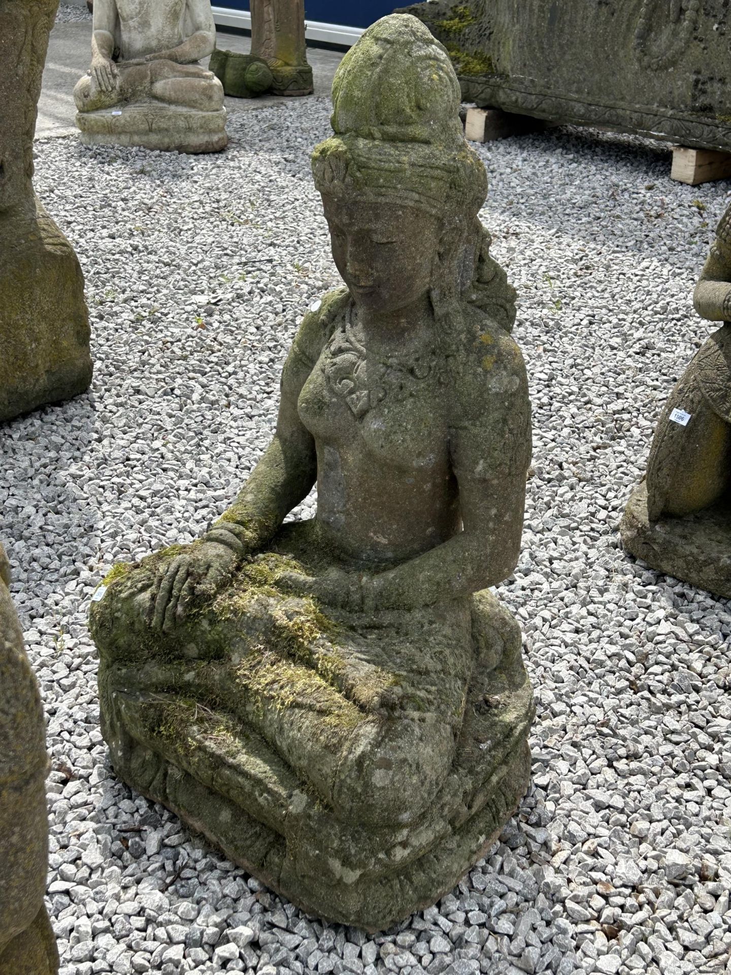 A LARGE RECONSTITUTED STONE BUDDHIST DIETY FIGURE - HEIGHT 104 CM, DEPTH 46 CM