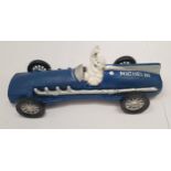 A CAST BLUE MICHELIN MAN IN A RACING CAR