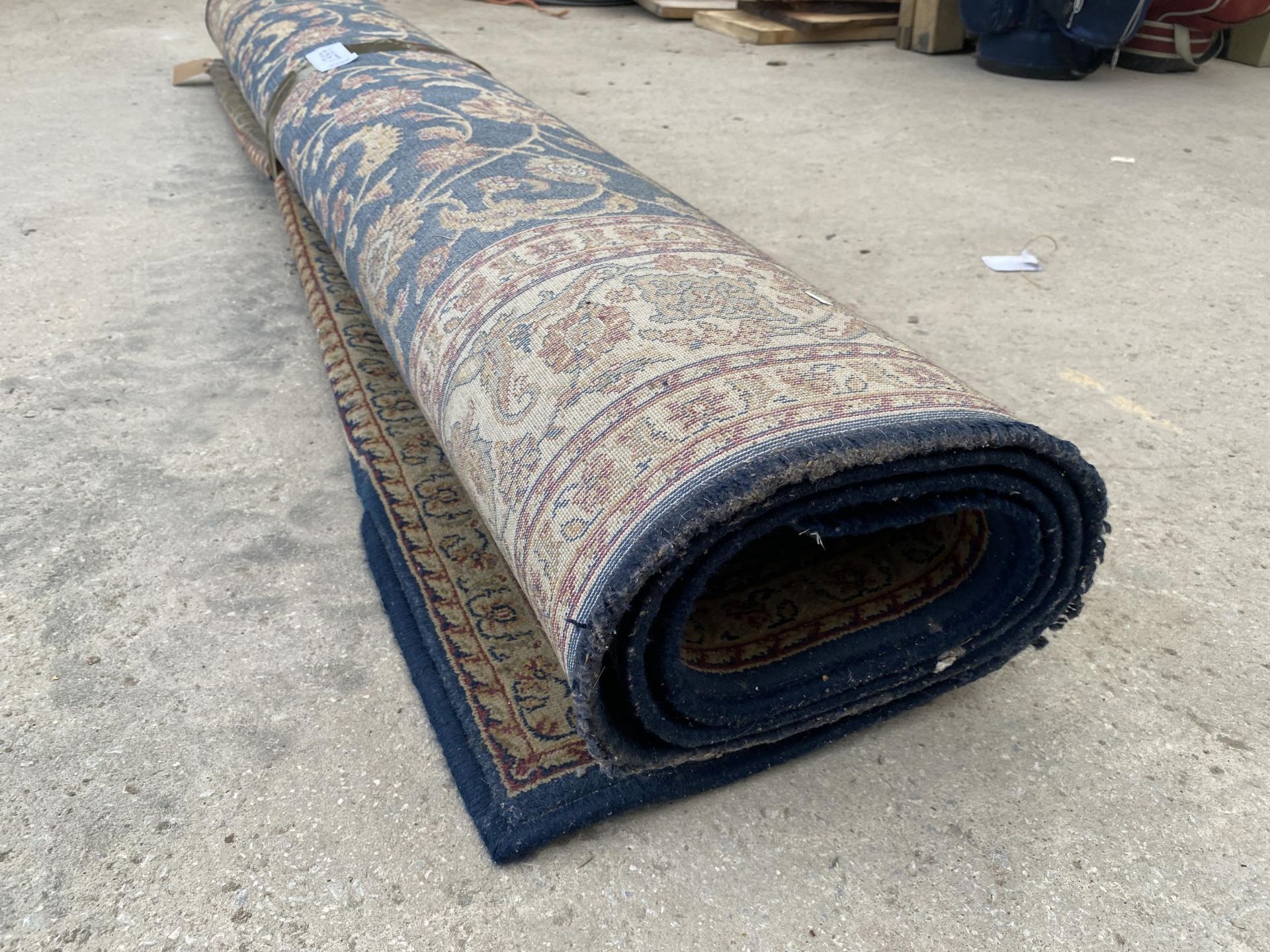 A BLUE AND RED PATTERNED RUG - Image 2 of 3