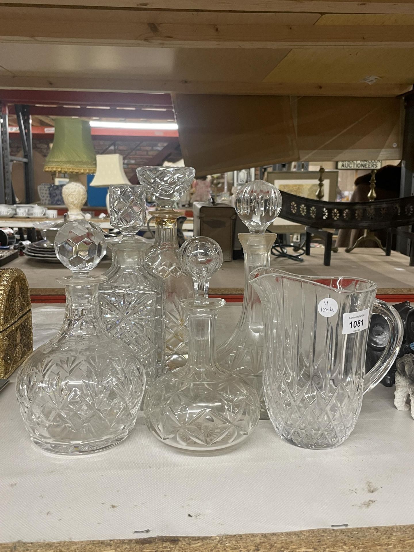 A COLLECTION OF CUT GLASS DECANTERS AND WATER JUG