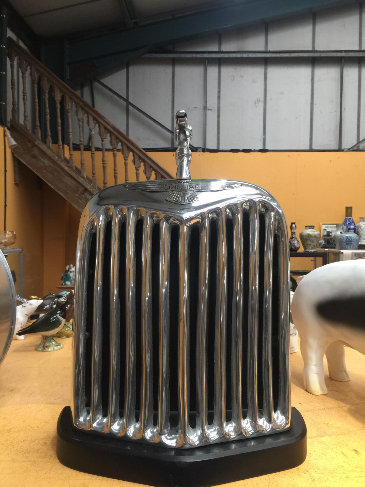 A CHROME STYLE JAGUAR RADIATOR ON BASE