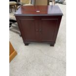 A SMALL MAHOGANY 'HOME ENTERTAINMENT COLLECTION' CUPBOARD, 23" WIDE