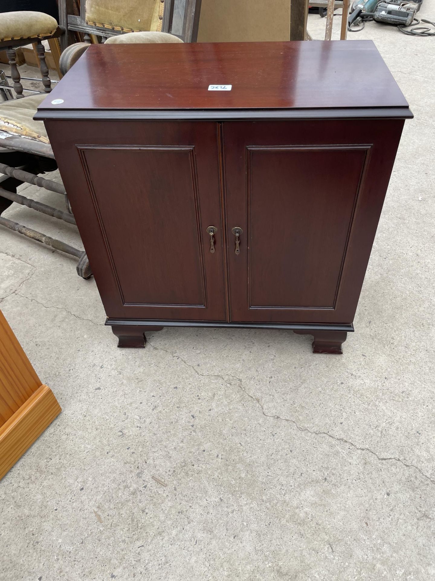 A SMALL MAHOGANY 'HOME ENTERTAINMENT COLLECTION' CUPBOARD, 23" WIDE