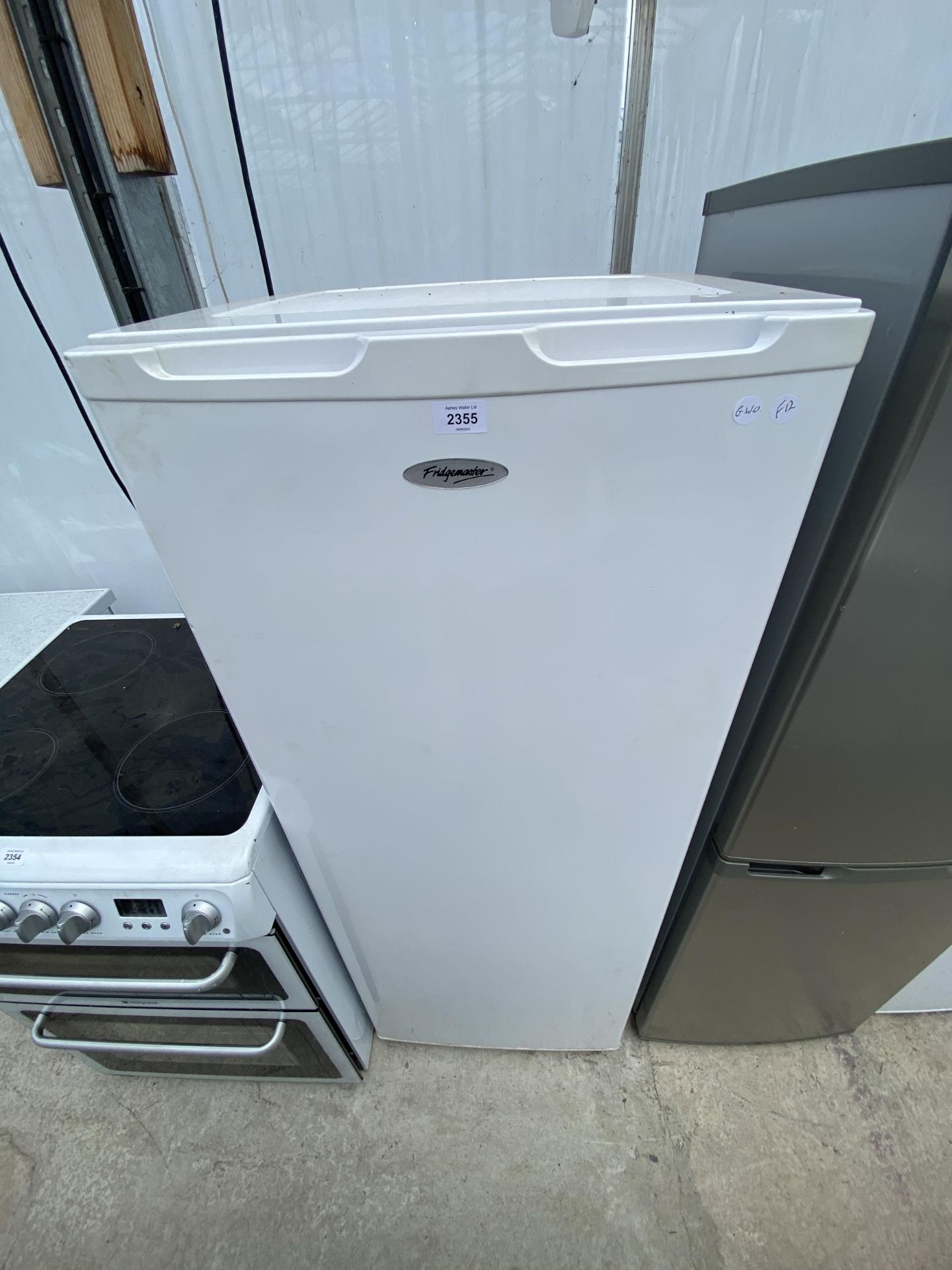 A TALL WHITE FRIDGEMASTER FREEZER