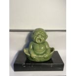 AN ORIENTAL BUDDAH ON A MARBLE BASE