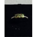 A 9CT GOLD RING WITH 3 PERIDOTS AND DIAMONDS WEIGHT 1.8G SIZE R AND A HALF