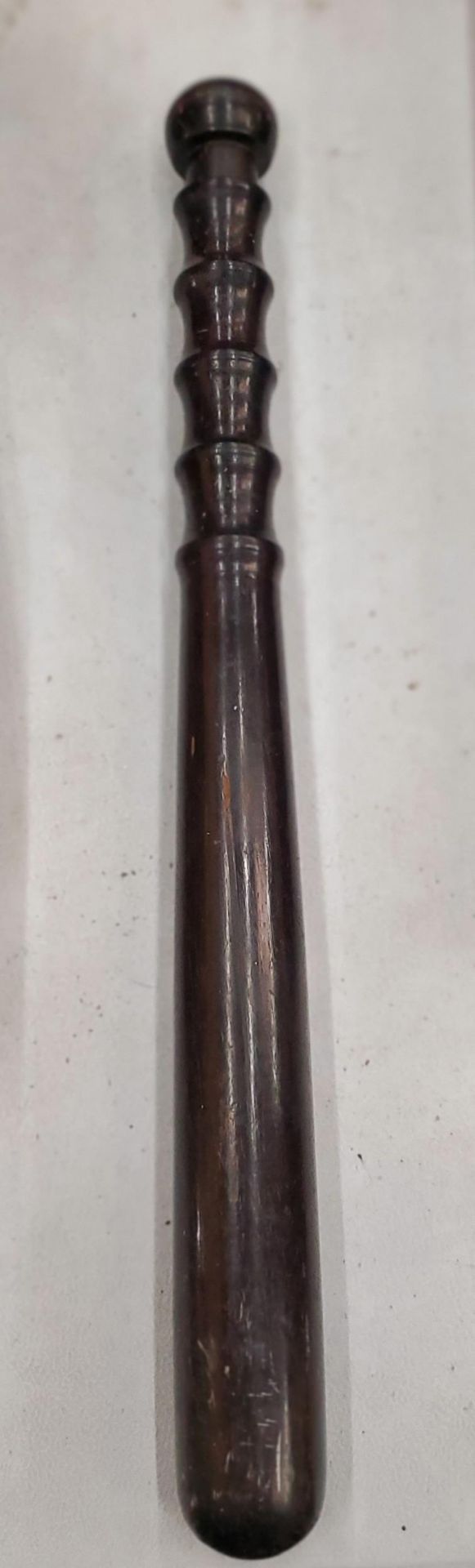 A LIGNUM VITAE EARLY 20TH CENTURY TRUNCHEON