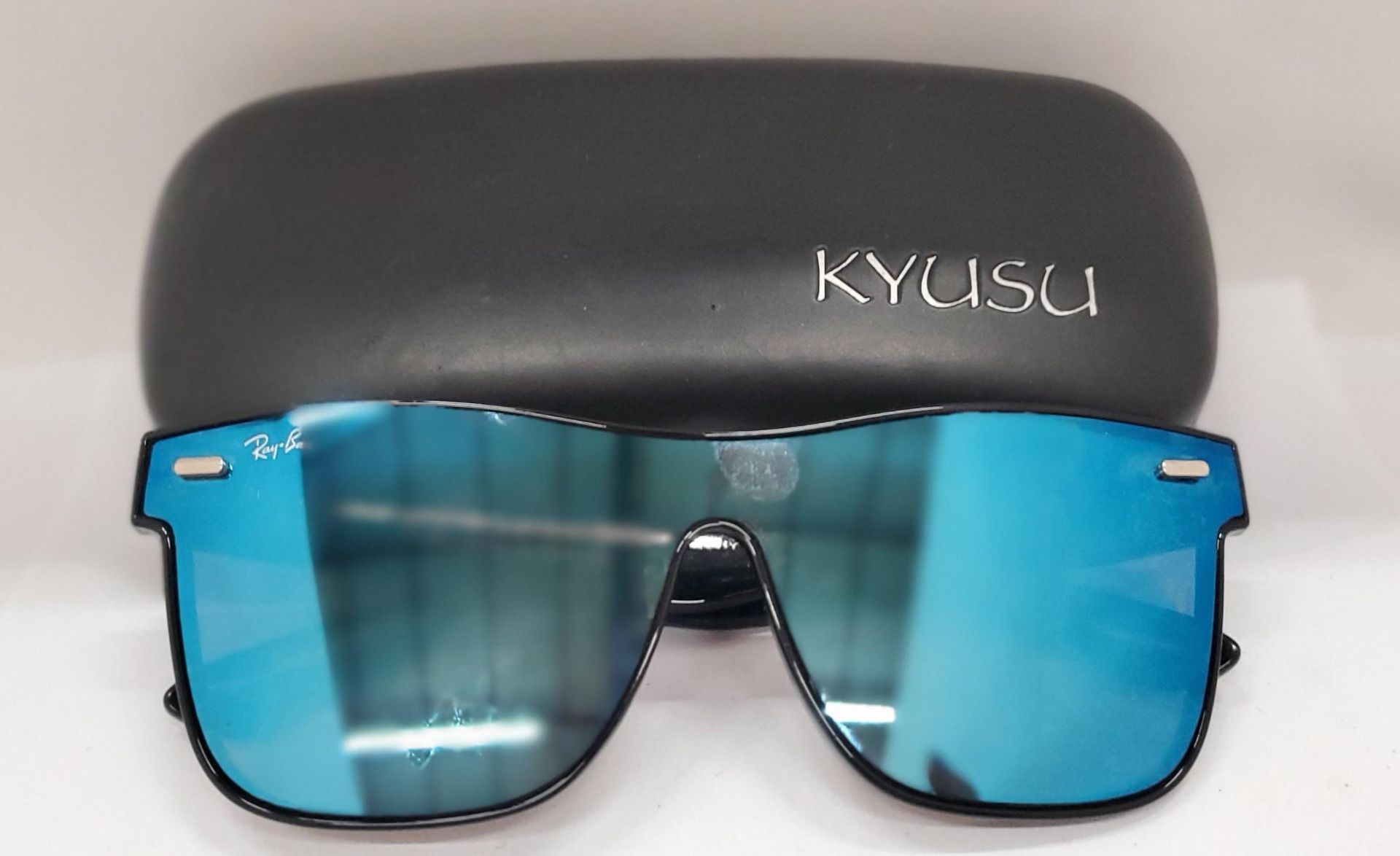 A PAIR OF SUNGLASSES MARKED 'RAY-BAN' IN A CASE