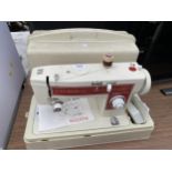 A TOYOTA SEWING MACHINE WITH CASE