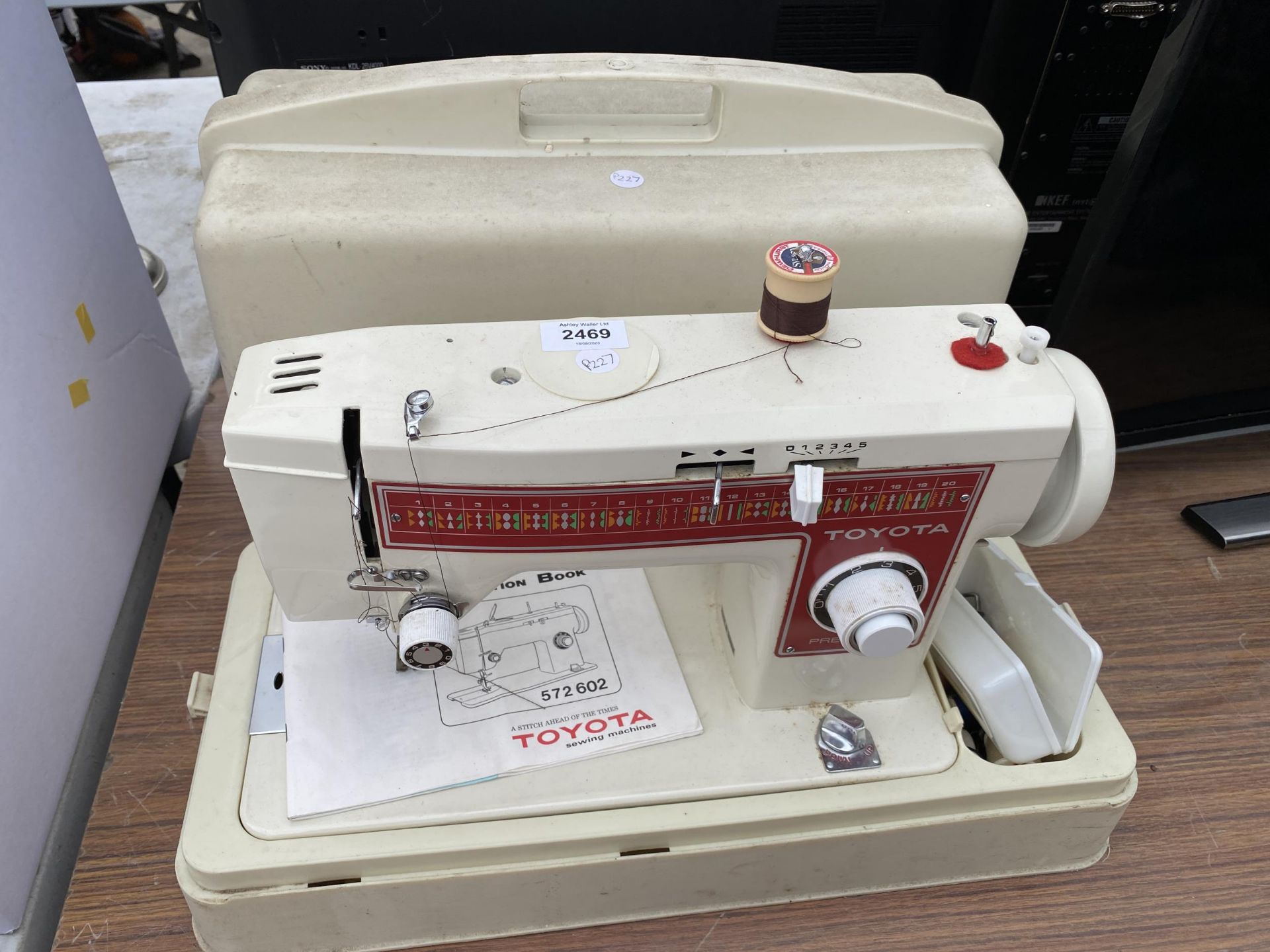 A TOYOTA SEWING MACHINE WITH CASE