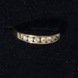 A 9CT GOLD RING WITH 7 CZ STONES, WEIGHT 1.6G, SIZE M