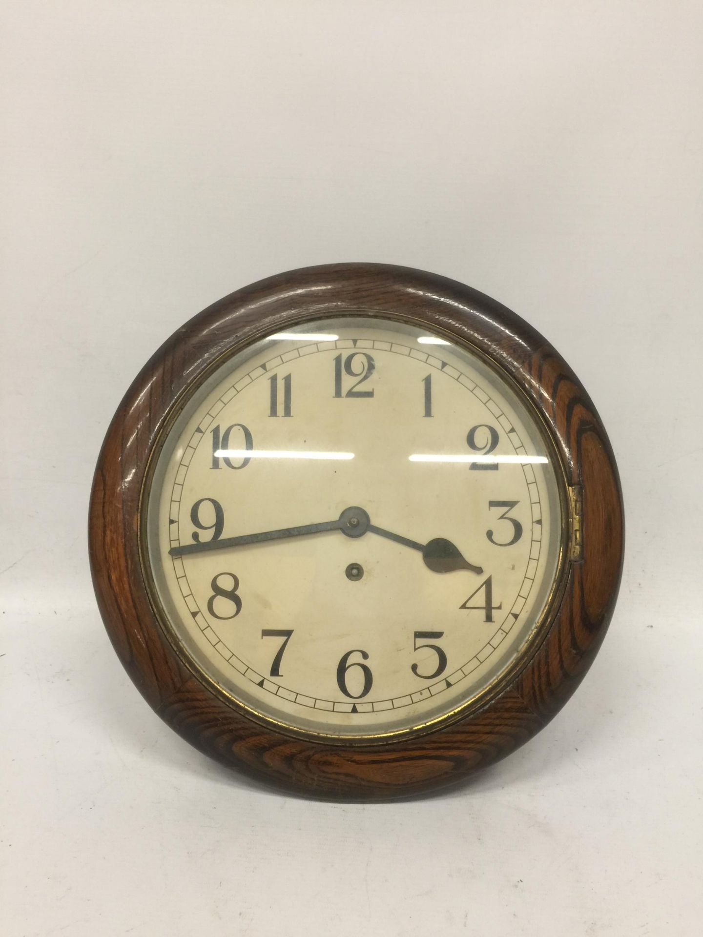 A VINTAGE CIRCULAR RAILWAY CHIMING CLOCK