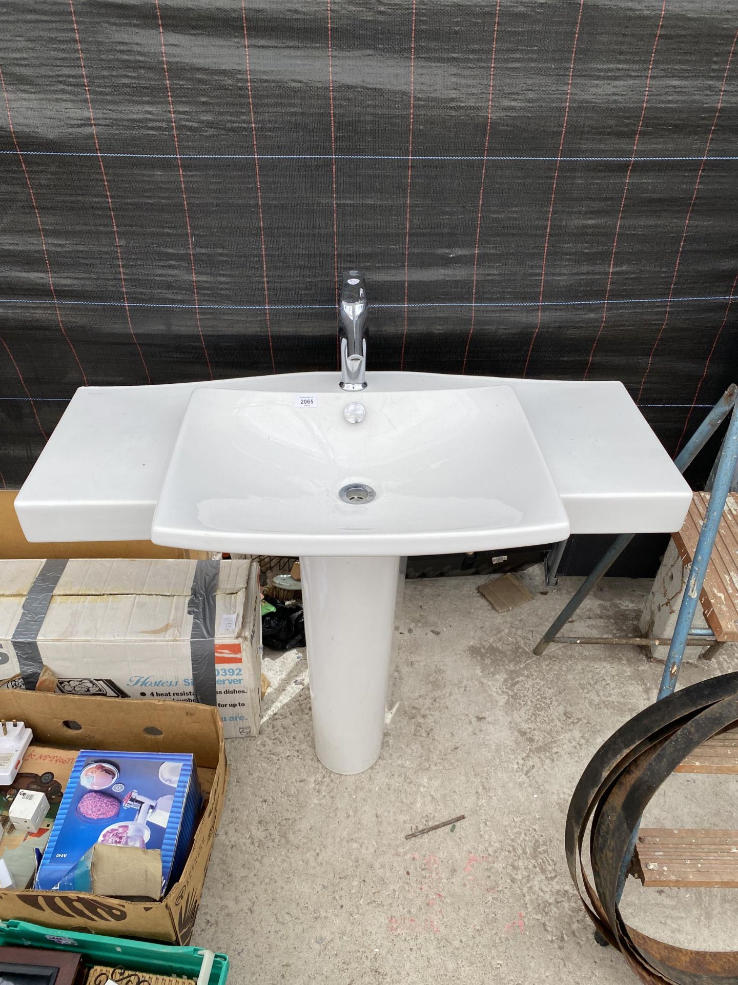 A WHITE CERAMIC SINK UNIT WITH CHROME TAP