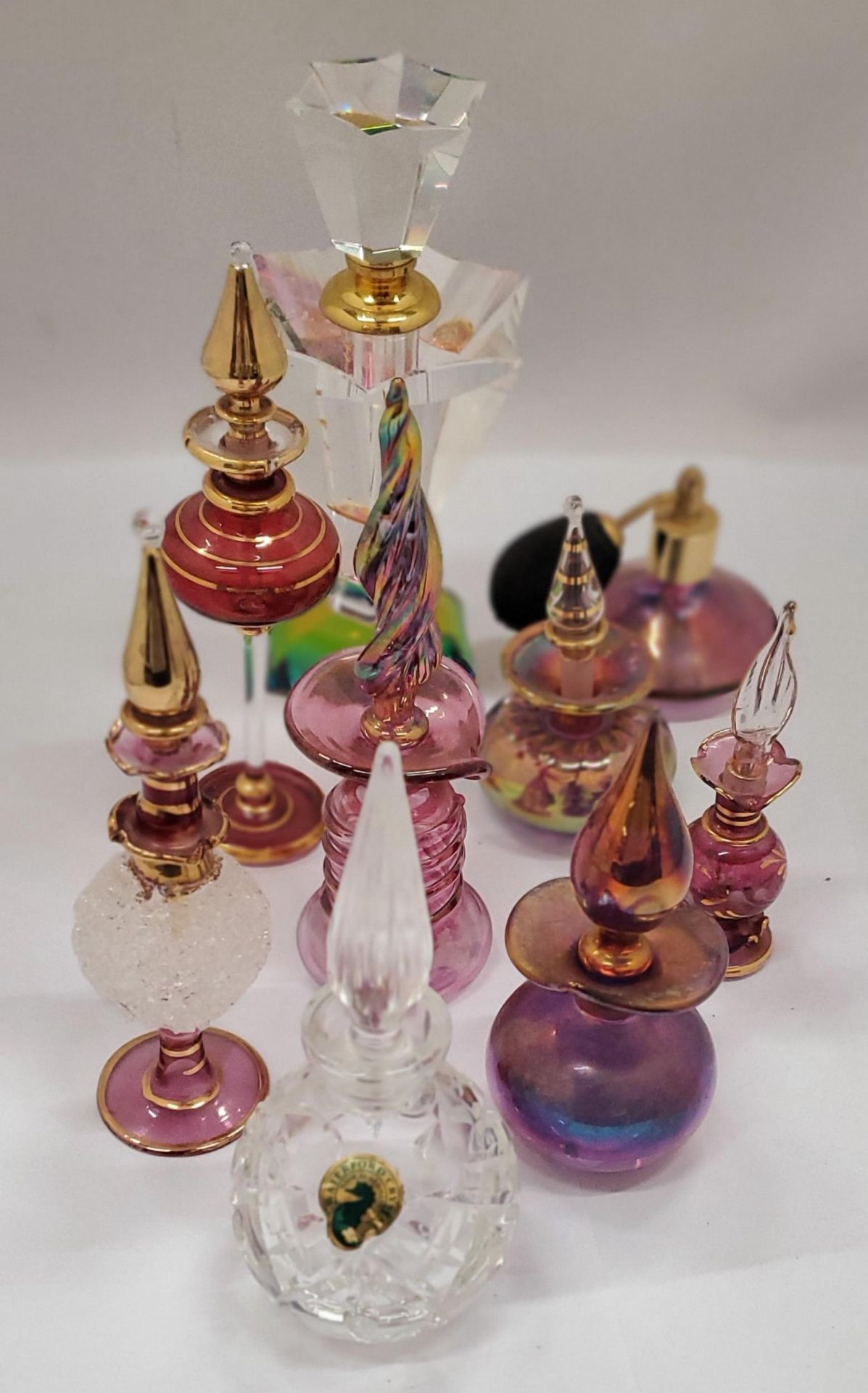 A COLLECTION OF GLASS SCENT BOTTLES WITH STOPPERS