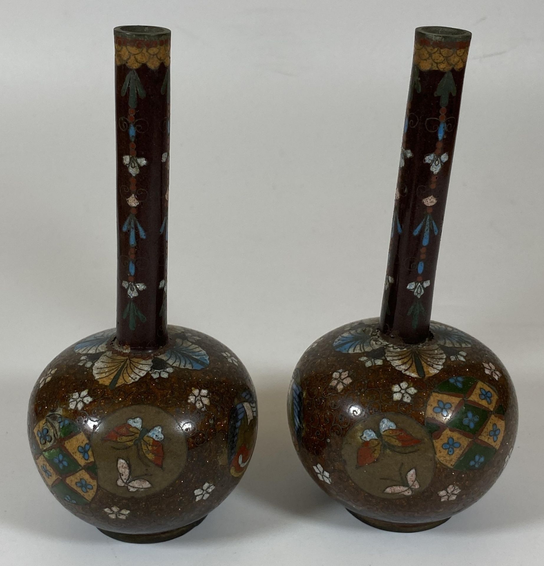 A PAIR OF JAPANESE MEIJI PERIOD (1868-1912) BUTTERFLY AND FLORAL DESIGN CLOISONNE BOTTLE VASES,