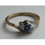 AN 18CT YELLOW GOLD AND PLATINUM, DIAMOND AND SAPPHIRE CROSSOVER RING SIZE L, WEIGHT 2.26 GRAMS