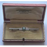 A 9CT WHITE GOLD ART DECO STYLE BROOCH WITH A BLUE TOPAZ AND ORIGINAL BOX, LENGTH 58MM, GROSS WEIGHT