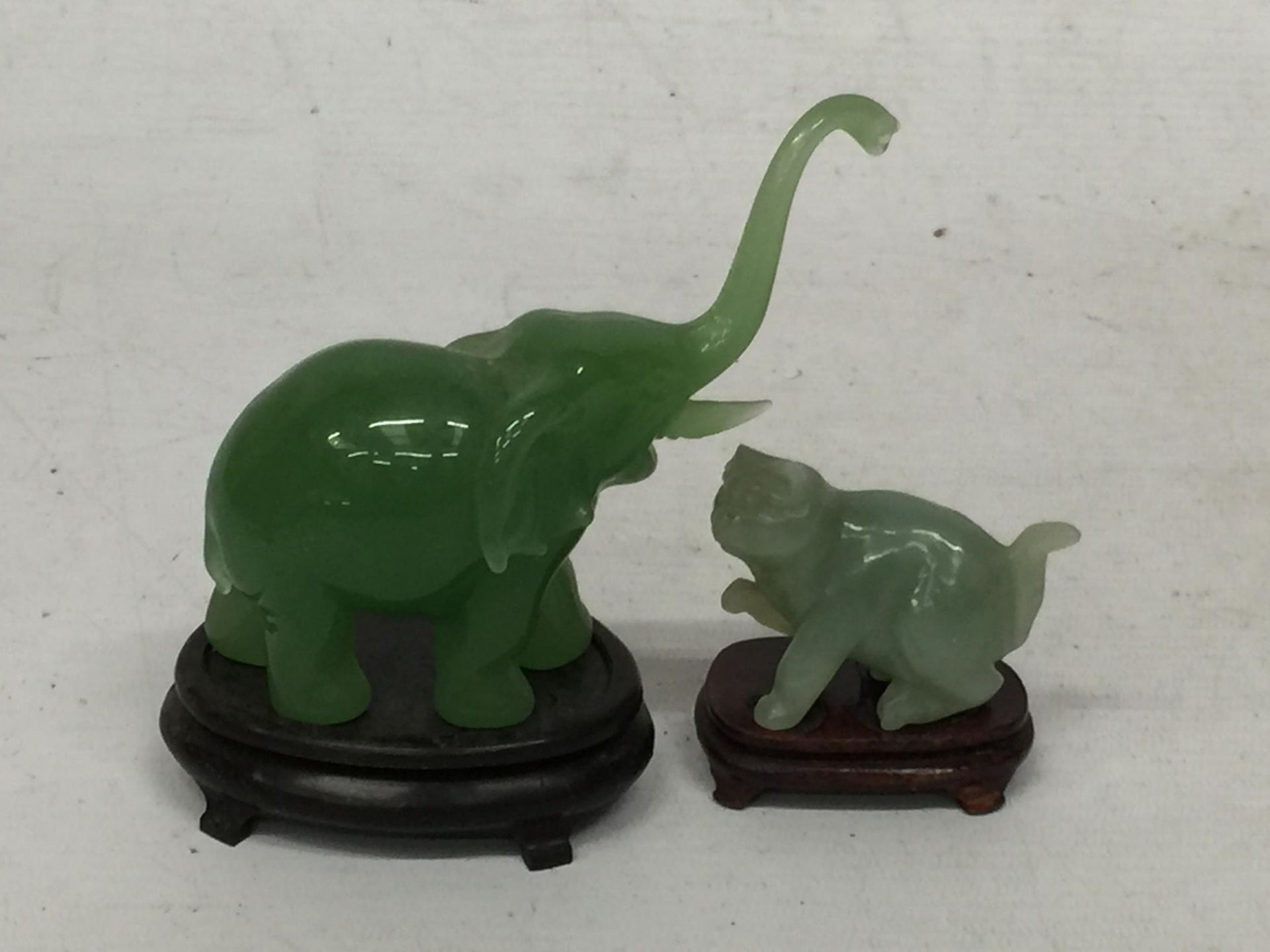 TWO JADE TYPE ANIMAL FIGURES ON STANDS - ELEPHANT AND CAT