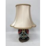 A MOORCROFT POPPY PATTERN TABLE LAMP WITH SILK SHADE