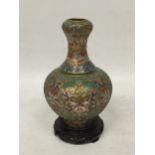 A VINTAGE ORIENTAL CLOISONNE BOTTLE SHAPED VASE ON WOODEN STAND