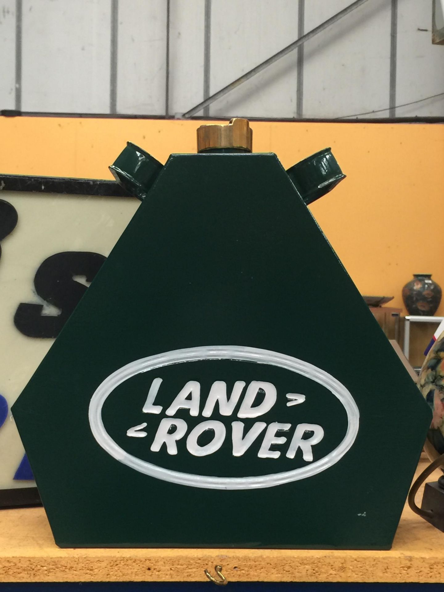 A GREEN METAL LAND ROVER PETROL CAN WITH BRASS TOP