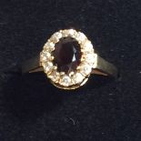 A 9CT GOLD RING WITH A RED GARNET AND CZ STONES, WEIGHT 2.1G, SIZE K