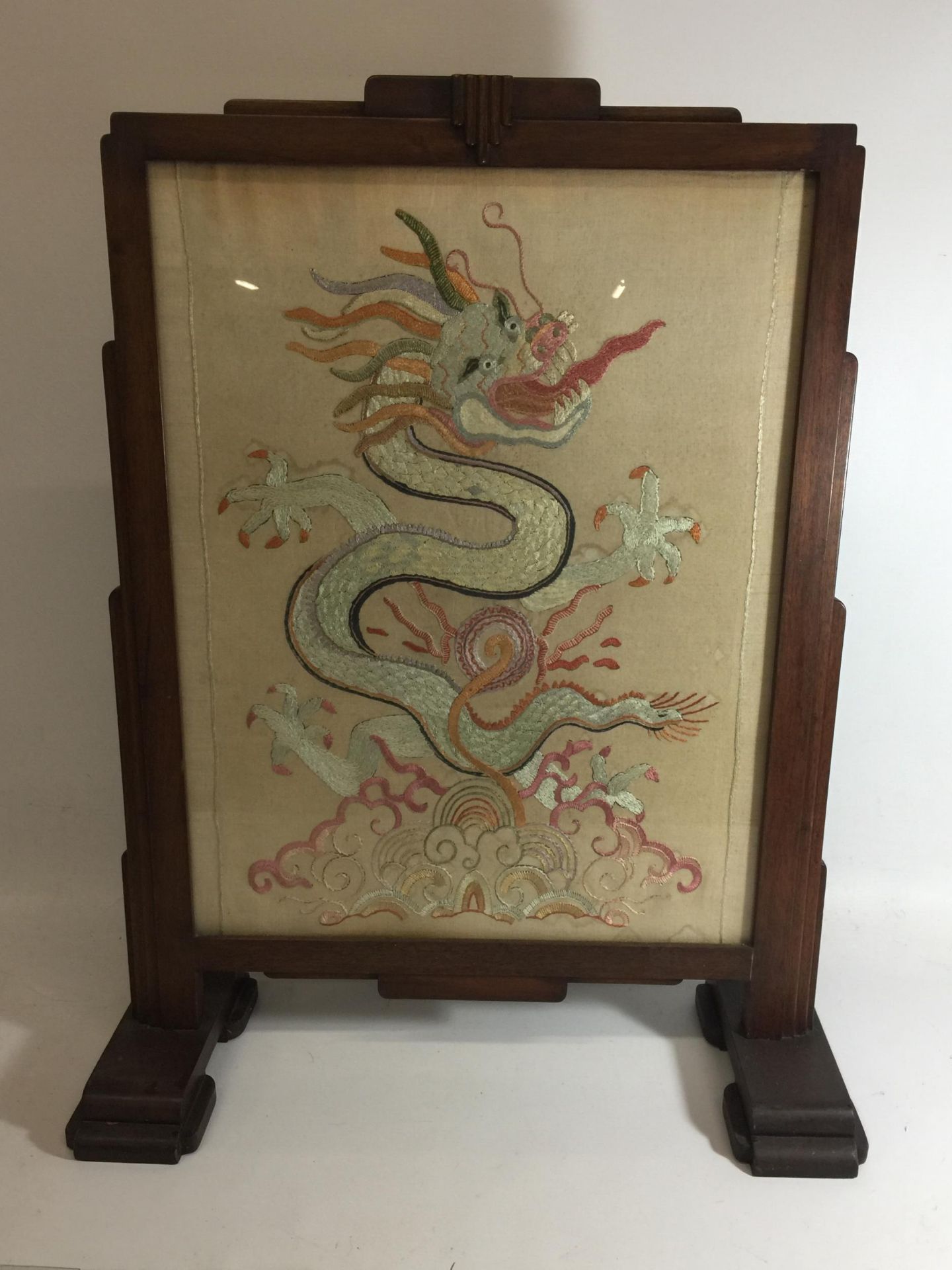 AN OAK FRAMED SILK DRAGON DESIGN FIRESCREEN