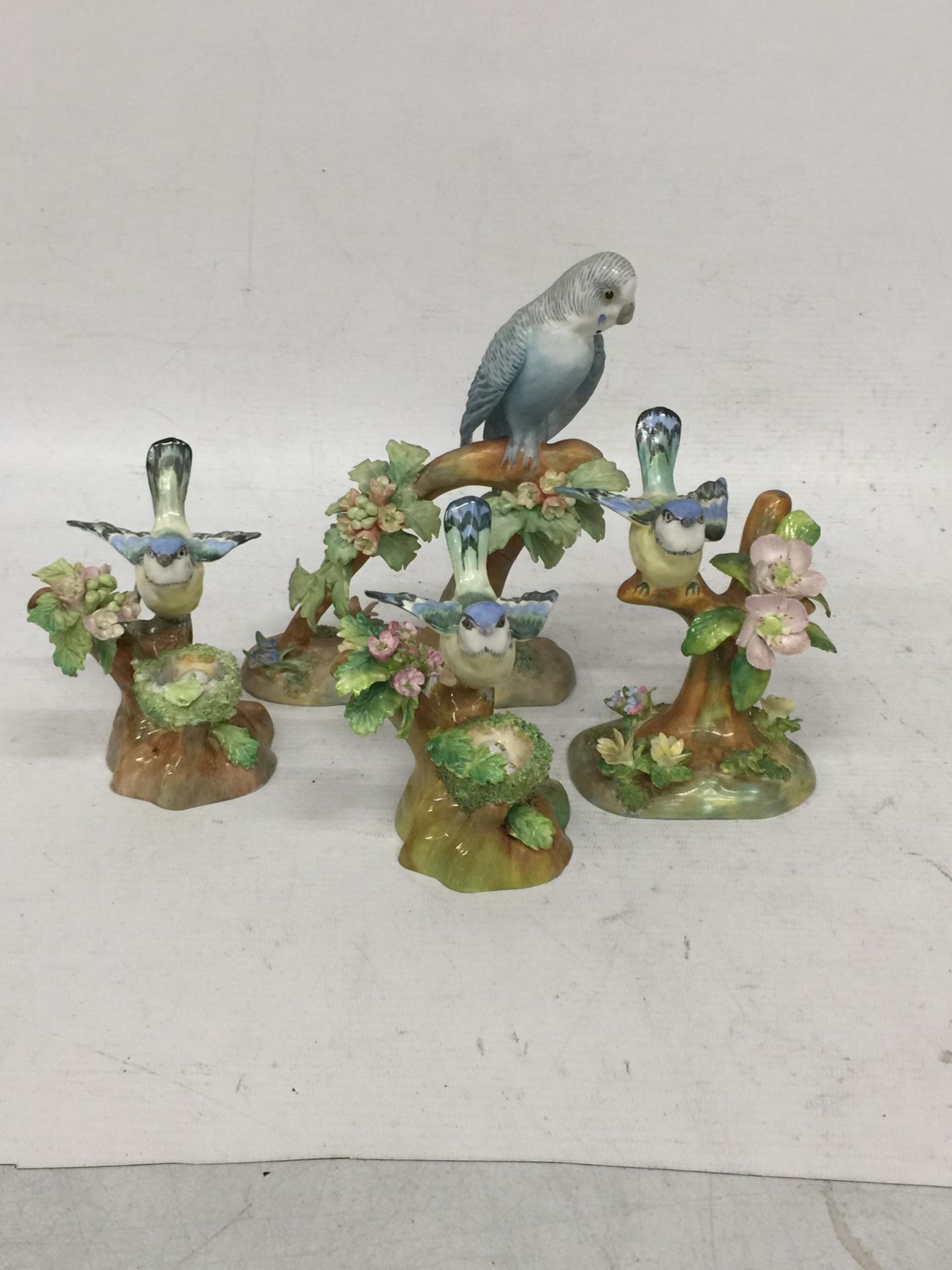 A SET OF FOUR CROWN STAFFORDSHIRE BIRD FIGURES, SOME AT FAULT