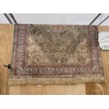 A MULTI COULOURED PATTERNED FRINGED RUG