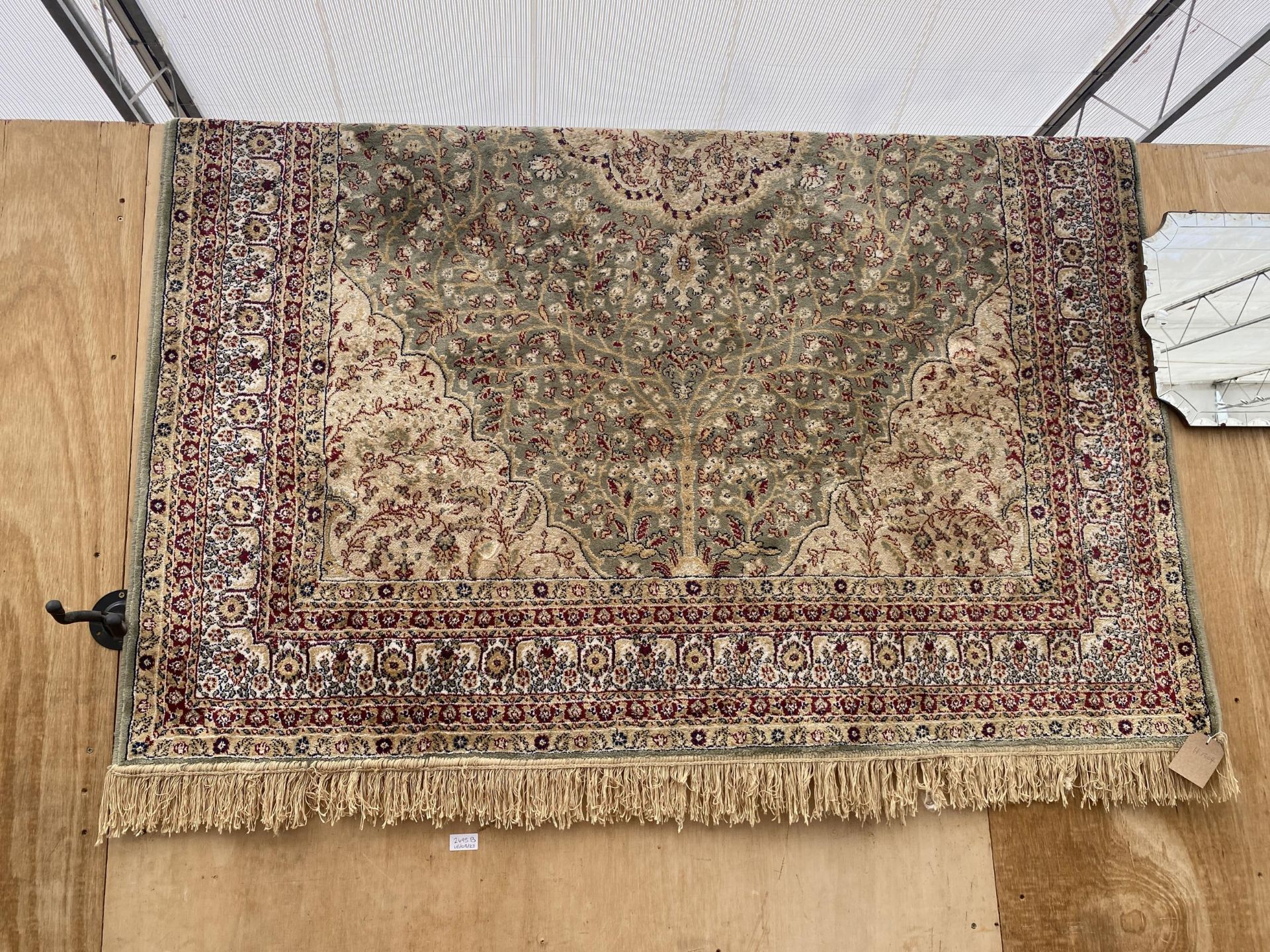 A MULTI COULOURED PATTERNED FRINGED RUG