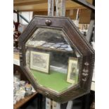 AN OCTAGONAL BEVEL EDGED BEADED MIRROR