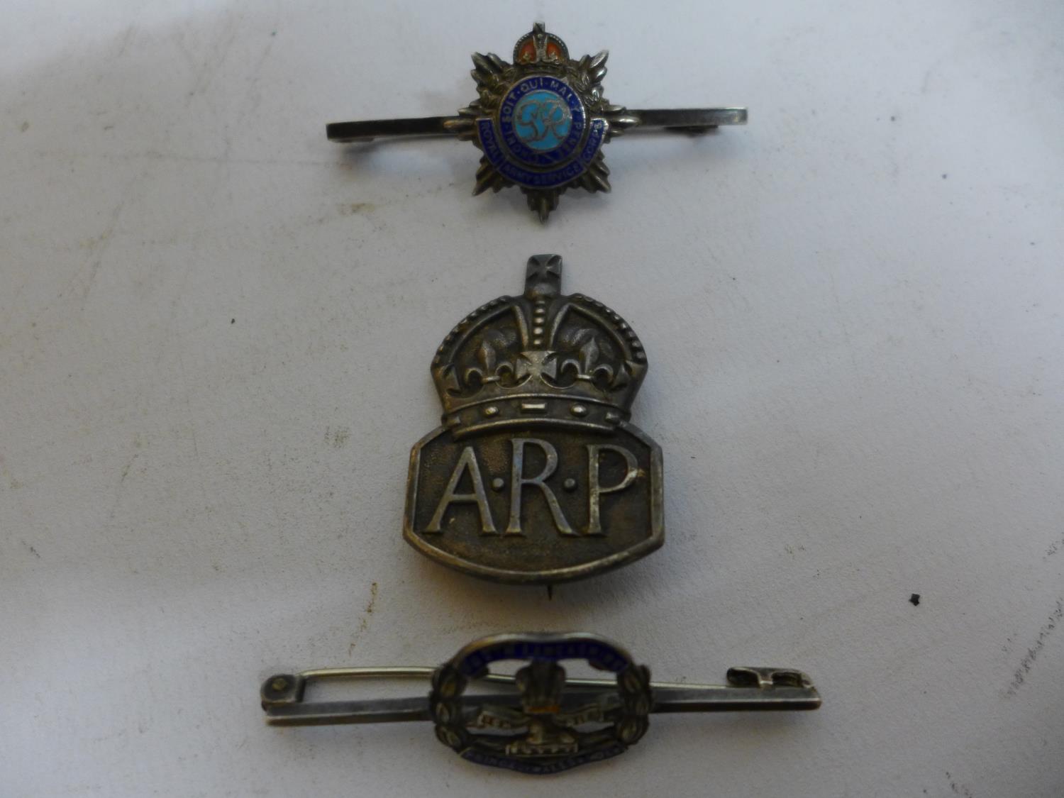 A SILVER WORLD WAR II A.R.P. BADGE AND TWO SILVER AND ENAMEL BROOCHES (3)