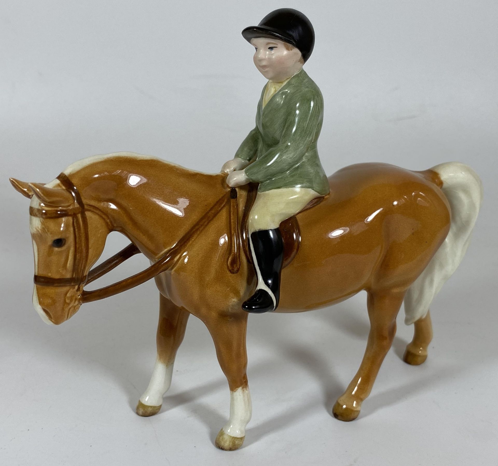 A BESWICK BOY ON PALOMINO PONY, MODEL NO. 1500, (HEAD RE-GLUED) ALSO FRONT LEG ALSO RE-GLUED