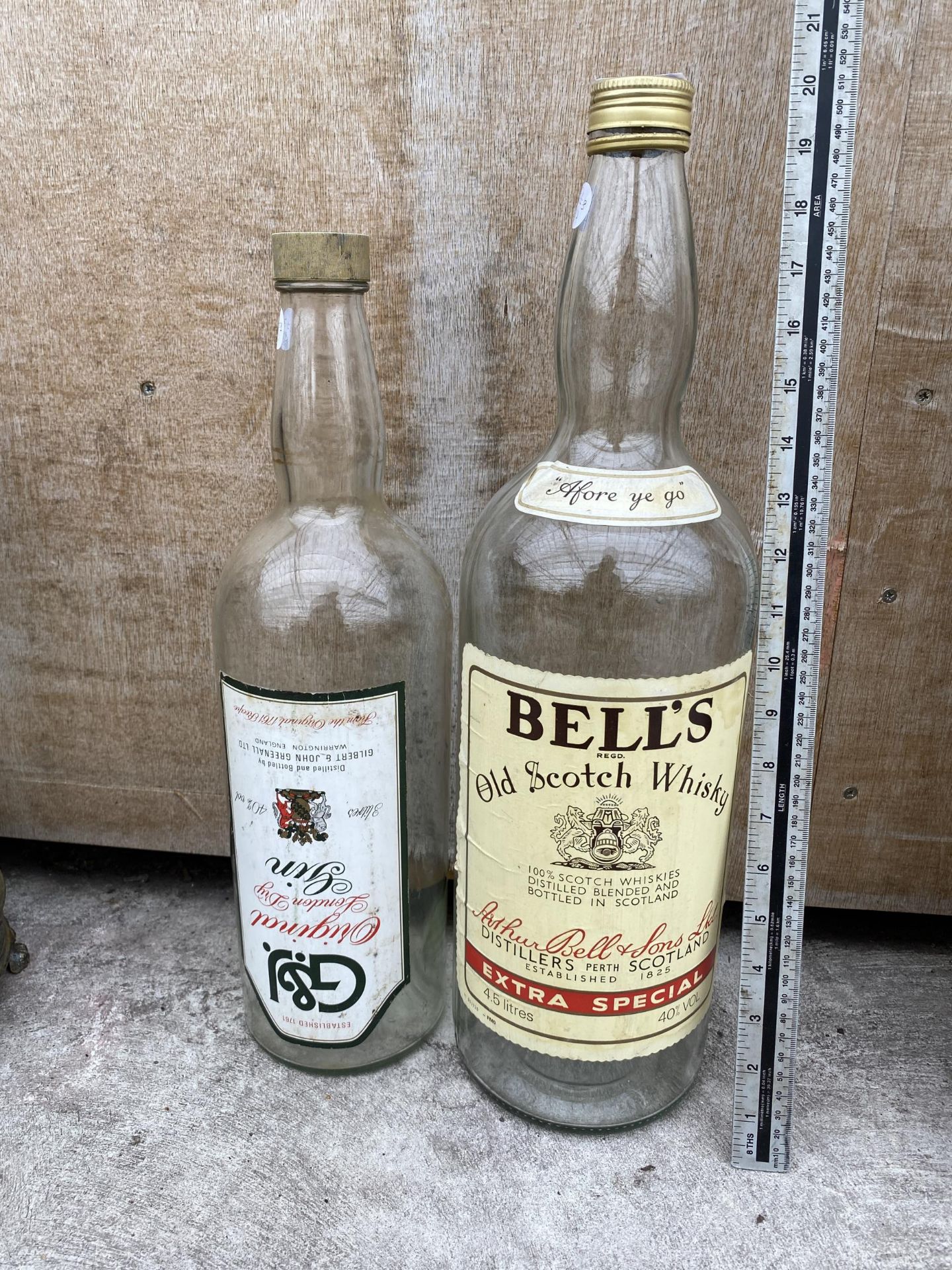 A LARGE BELLS SCOTCH WHISKEY BOTTLE AND A LARGE GIN BOTTLE