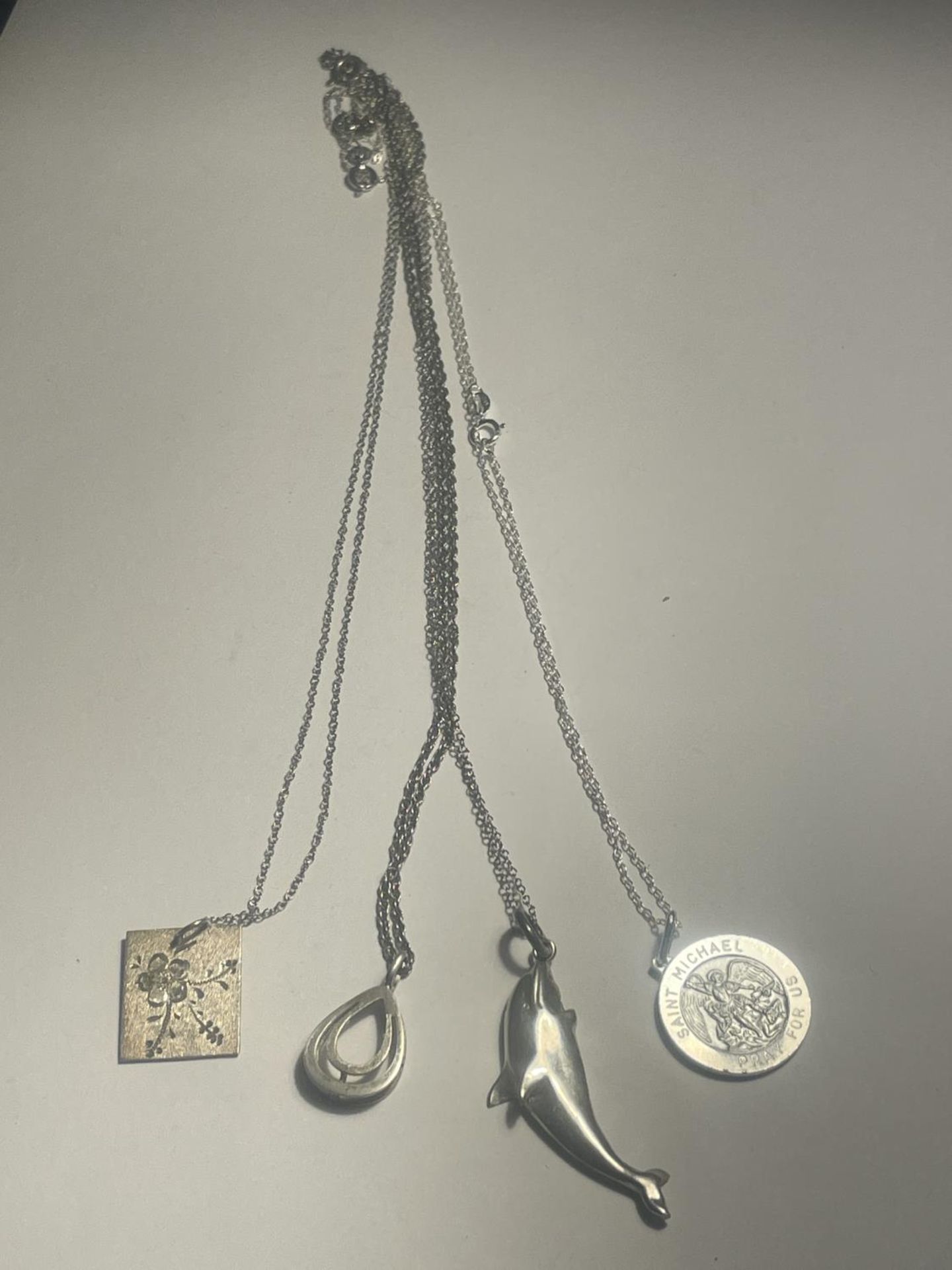 FOUR SILVER NECKLACES WITH PENDANTS