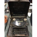 A VINTAGE 'THE EMPIRE' TYPEWRITER IN METAL CASE