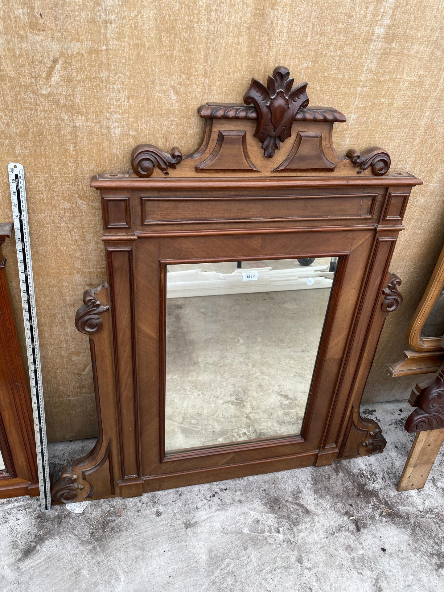 A DECORATIVE MAHOGANY FRAMED OVER MANTLE WALL MIRROR