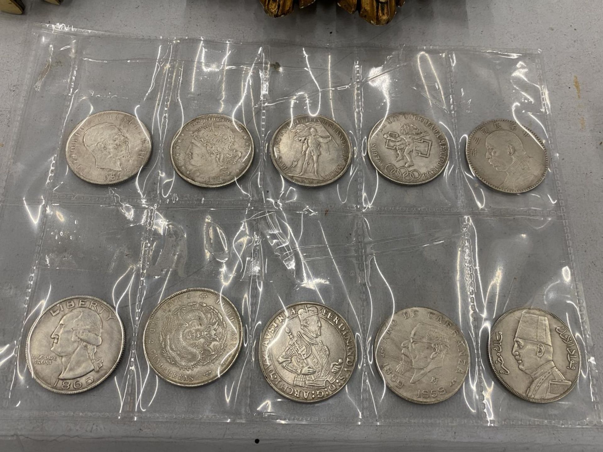 TEN COLLECTORS FOREIGN COINS TO INCLUDE AN 1865 US DOLLAR, ETC