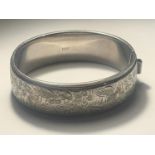 AN ORNATE SILVER BANGLE