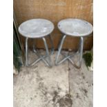 A PAIR OF ALLOY STOOLS WITH STEEL LEGS